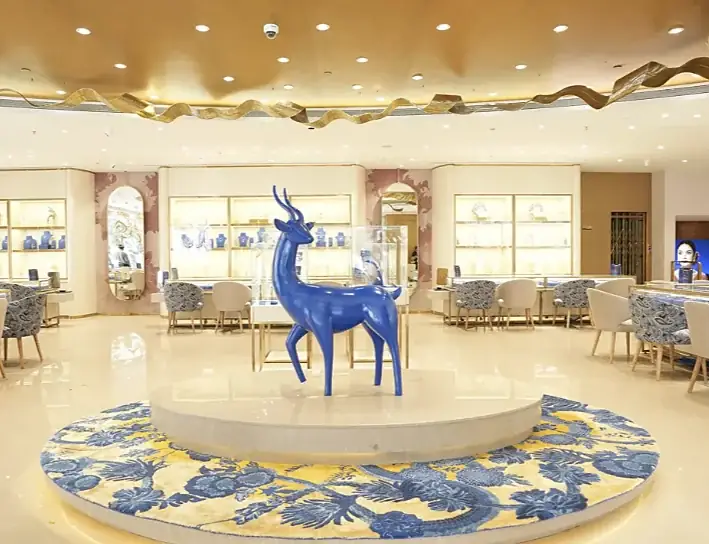 Blue deer sculpture beneath the sculpted gold ceiling of the Indriya Borivali store