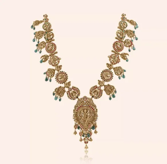 Lakshmi Bottu Mala long gold temple necklace with coin motifs, green drops and a Lakshmi pendant