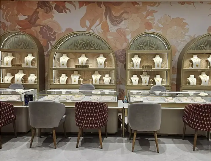 A row of arched necklace cabinets above glass counters at Indriya Phoenix Marketcity