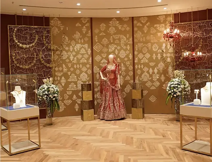 Bridal display with a red lehenga and necklace stands at Indriya Sky City Mall
